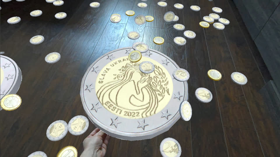 A two-euro commemorative coin stretched to the size of a dinner plate